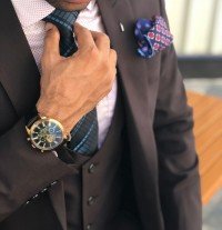 man in formal suit jacket holding his necktie 1342609